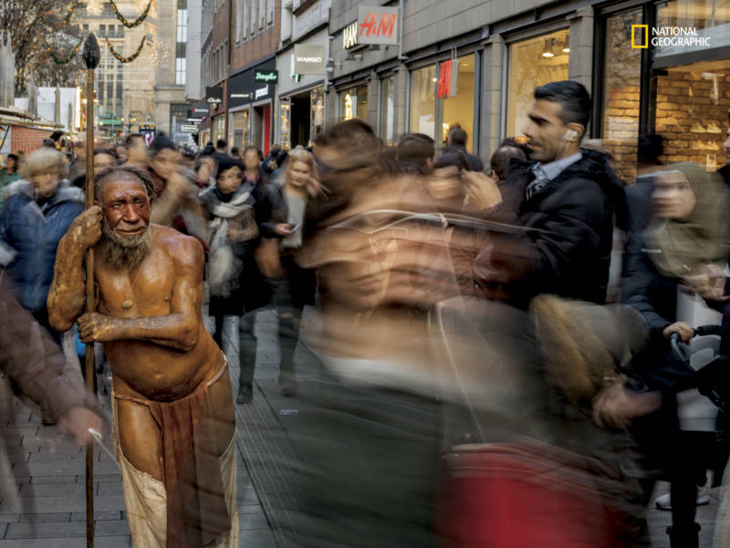 In Düsseldorf, Germany, a sculpture from the nearby Neanderthal Museum draws curiosity and recognition from passersby. The image is featured in the April issue of National Geographic magazine, a single-topic issue on the subject of race