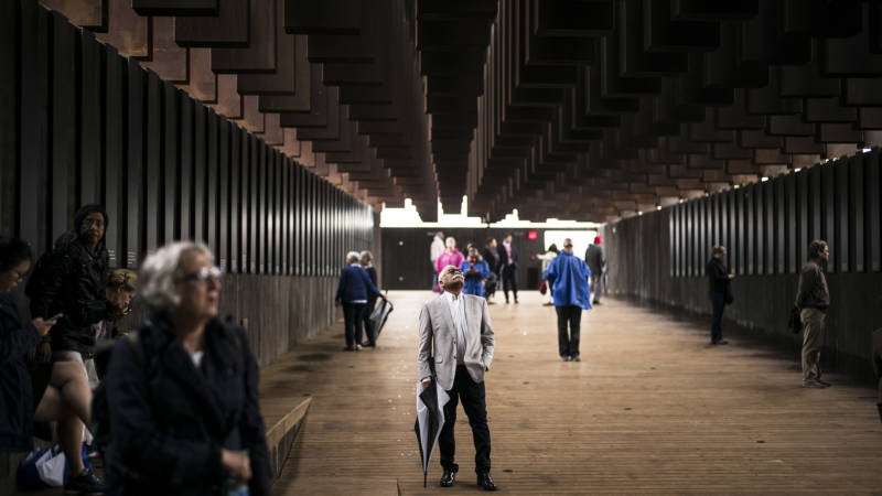 Ed Sykes (center), 77, visits the National Memorial For Peace And Justice on April 26, 2018 in Montgomery, Alabama. Sykes, who has family in Mississippi, was distraught when he discovered his last name in the memorial, three months after finding it on separate memorial in Clay County, Mississippi. "This is the second time I've seen the name Sykes as a hanging victim. What can I say?" Sykes, who now lives in San Francisco, plans to investigate the lynching of a possible relative at the Equal Justice Initiative headquarters in Montgomery before returning to California. The memorial is dedicated to the legacy of enslaved black people and those terrorized by lynching and Jim Crow segregation in America. Conceived by the Equal Justice Initiative, the physical environment is intended to foster reflection on America's history of racial inequality.