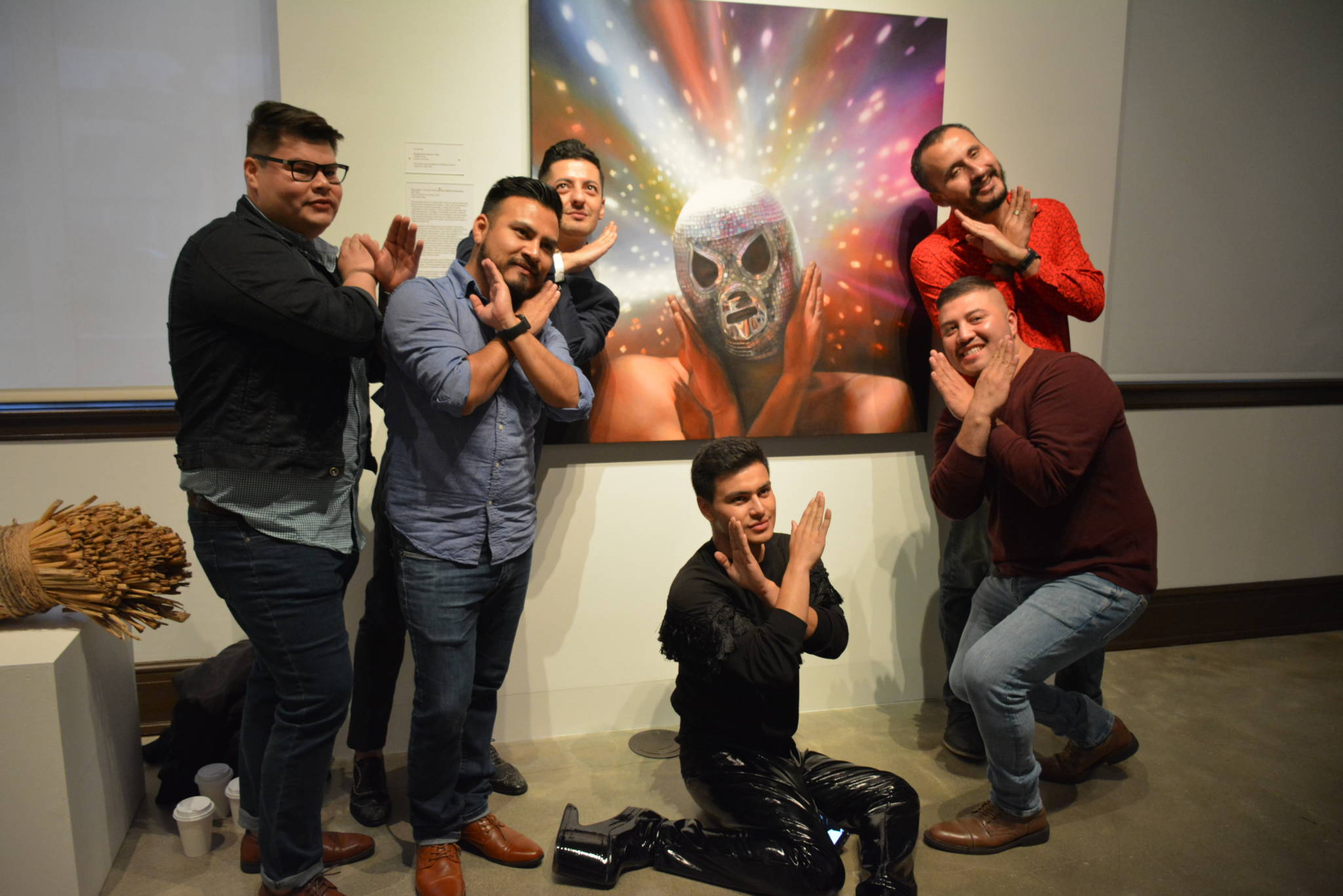 Orlando de la Garza with his painting and friends at the SFAC gallery.
