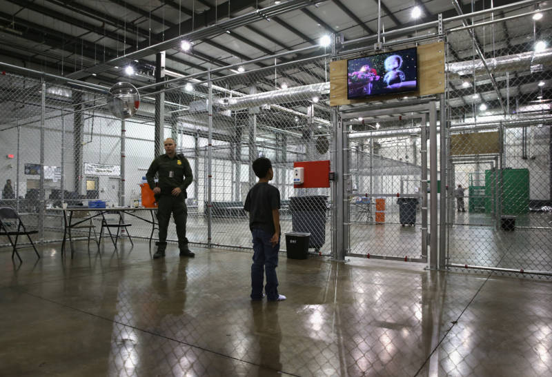 A boy from Honduras watches a movie at a detention facility run by the U.S. Border Patrol in McAllen, Texas, in 2014. The Border Patrol opened the holding center to temporarily house the children after tens of thousands of families and unaccompanied minors from Central America crossed the border illegally into the United States during the spring and summer.