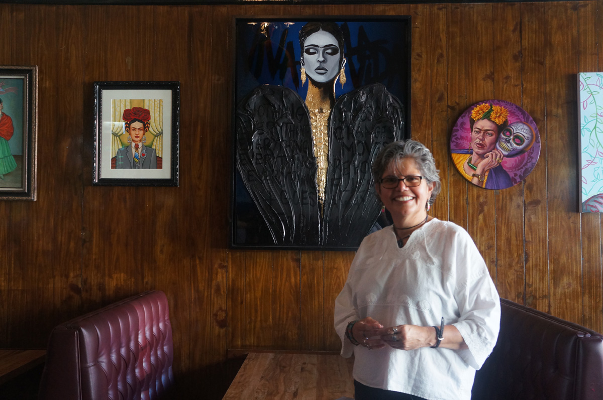 Amparo Vigil, one of Puerto Alegre's co-owners, in front of the Frida Kahlo tribute show she organized.