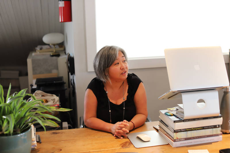 Lonnie Lee at her desk in Vessel Gallery. The landlord for the building in Oaklan'ds Uptown neighborhood has declined to renew Vessel Gallery's lease.