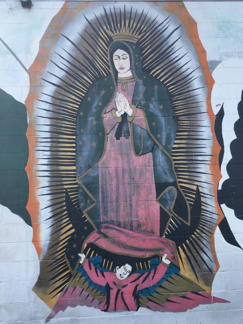 What's left of a larger mural that included the Virgen de Guadalupe by an unknown artist on the wall of Cal Foods Tienda y Carniceria in the Five Wounds neighborhood of San Jose.