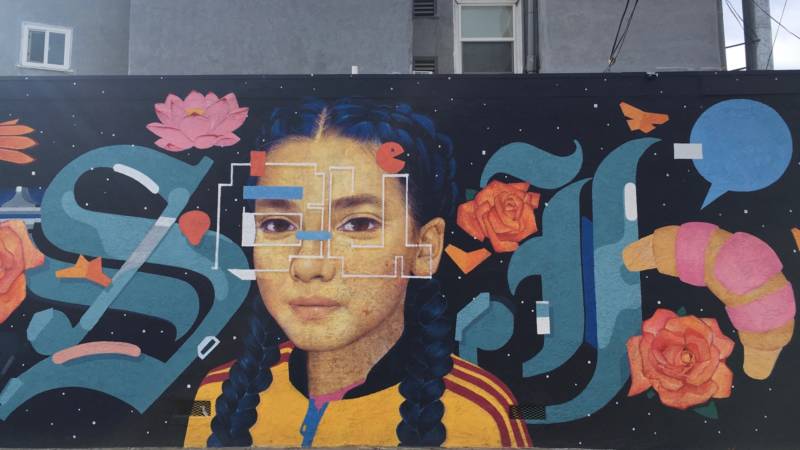 Detail of "Here & There" by Sam Rodriguez in San Jose's Japantown. The more you look, the more you see, like the letters "S" and "J" in Olde English font on either side of his daughter's face. You know: SJ, for San Jose.