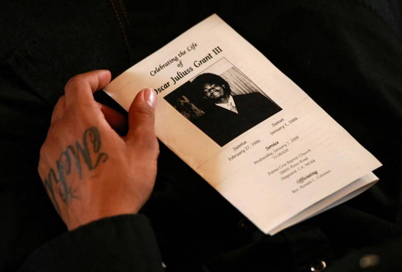A mourner holds holds a program during funeral services for twenty two year-old Oscar Grant III at Palma Ceia Baptist Church Jan. 7, 2009 in Hayward.