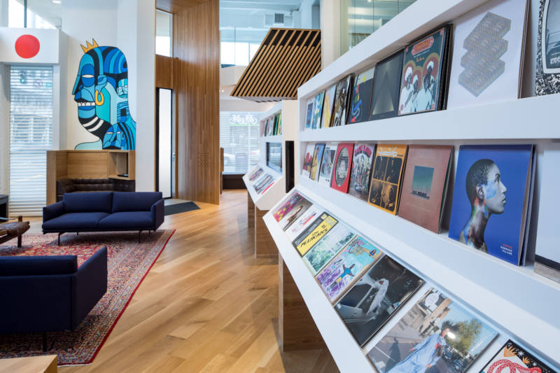 The first thing visitors encounter at Bandcamp’s new office is a rotating display of 99 vinyl LPs.