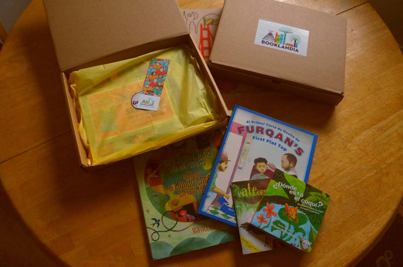 A Booklandia subscription box featuring Robert Trujillo's 'Furquan's First Flat Top,' Eduardo Espada's 'Donde Esta El Coqui' and more.