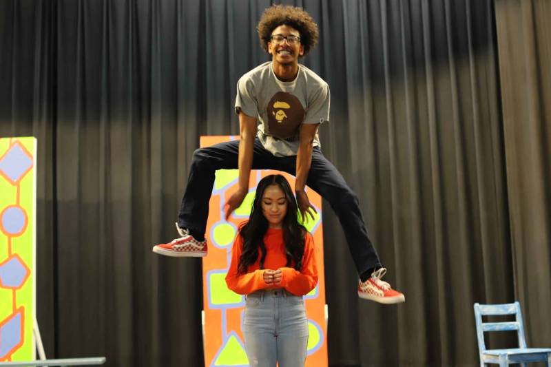 Trevahn Srey leaps over Trinity Chau during rehearsals for 'Hairspray' at Oakland High School.