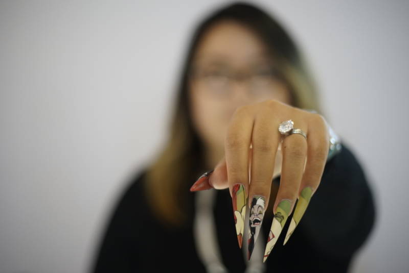 Vivian Xue Rahey, owner of Pamper Nail Gallery, displays her latest nail art.