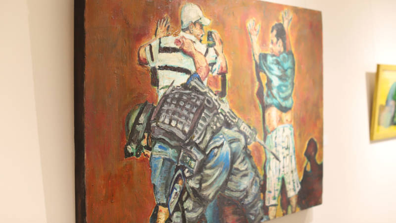 Adrian Delgado's "Search/Buscar" has remained in the show despite also showing a soldier with a gun.