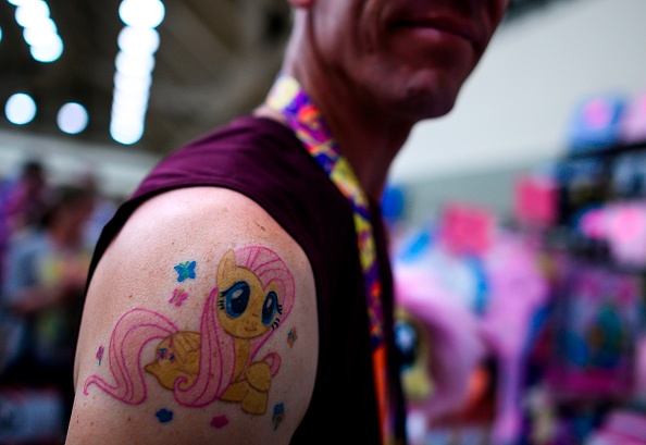 A man shows off his 'My Little Pony' tattoo during BronyCon 2019. 