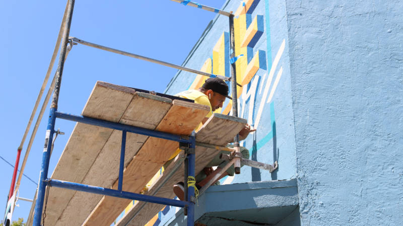 Critical Resistance commissioned muralist-activists Leslie “Dime” Lopez and Dominic “Treat U Nice” Villeda (pictured) to paint the building.