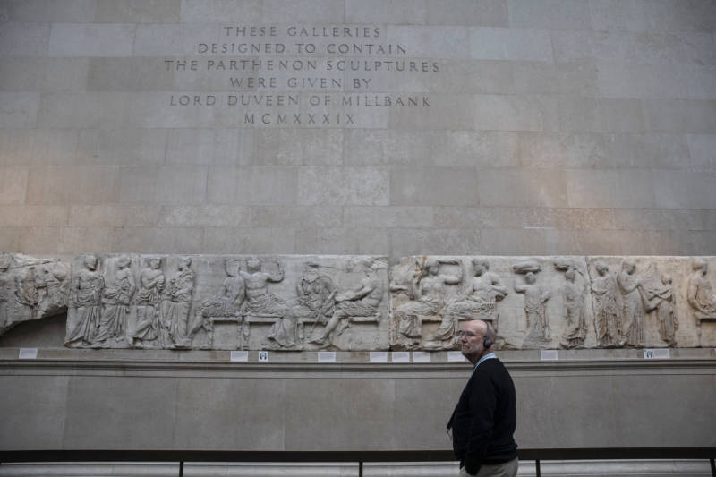 A tourist makes his way through classical sculptures from the Parthenon, also known as the Elgin marbles, at the British Museum in 2018.