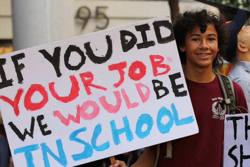Demonstrators at the Climate Strike in San Francisco on Sept. 20, 2019. A teenage boy holds a sign that says "If you did your job we would be in school."