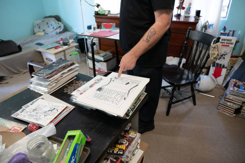 Stacks of comics and drawings abound in Tom Beland's $800/month room in a shared Santa Rosa house.