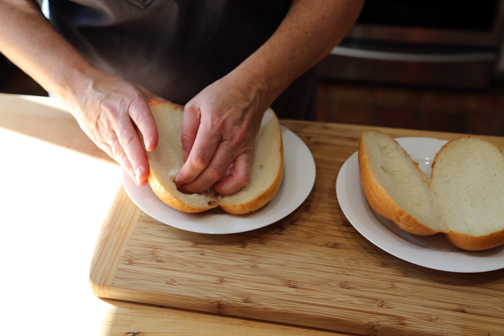 To make the sandwiches, split the rolls, and roughly hollow out the top.