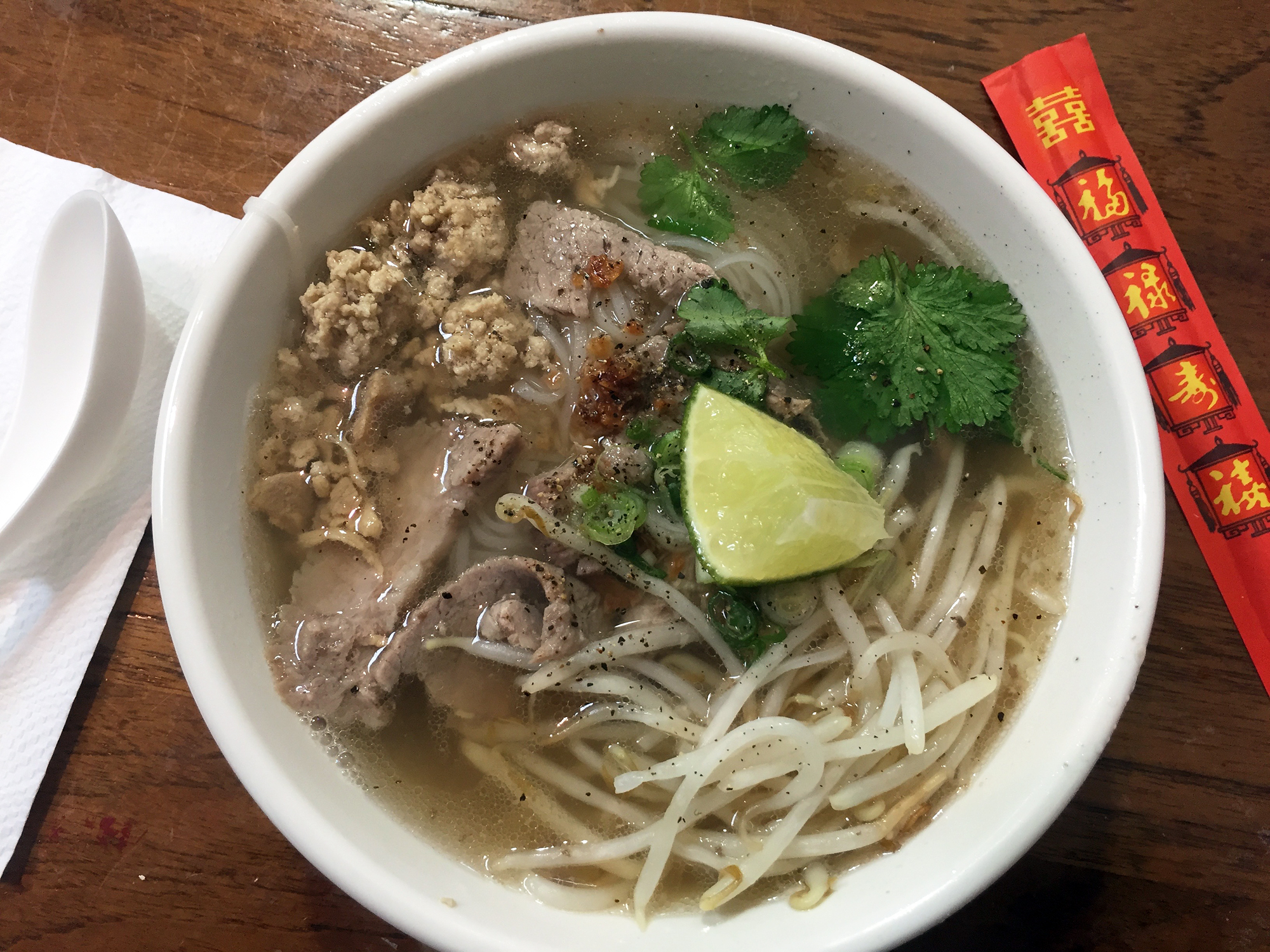The Phnom Penh features rice noodles, sliced and ground pork in a rich pork and shrimp broth, garnished with crispy garlic, cilantro, scallions and bean sprouts.