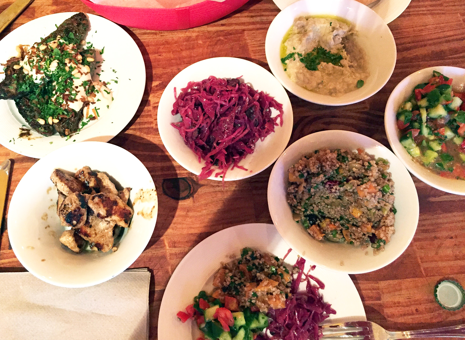 A generous spread at Ba-Bite, including butternut squash and quinoa salad with cranberries and pumpkin seeds; Salad Shirazi (cucumbers, tomatoes, parsley and mint), Red Cabbage salad, Baba Ganoush, Lamb Kefta and  Chicken Shishlik.