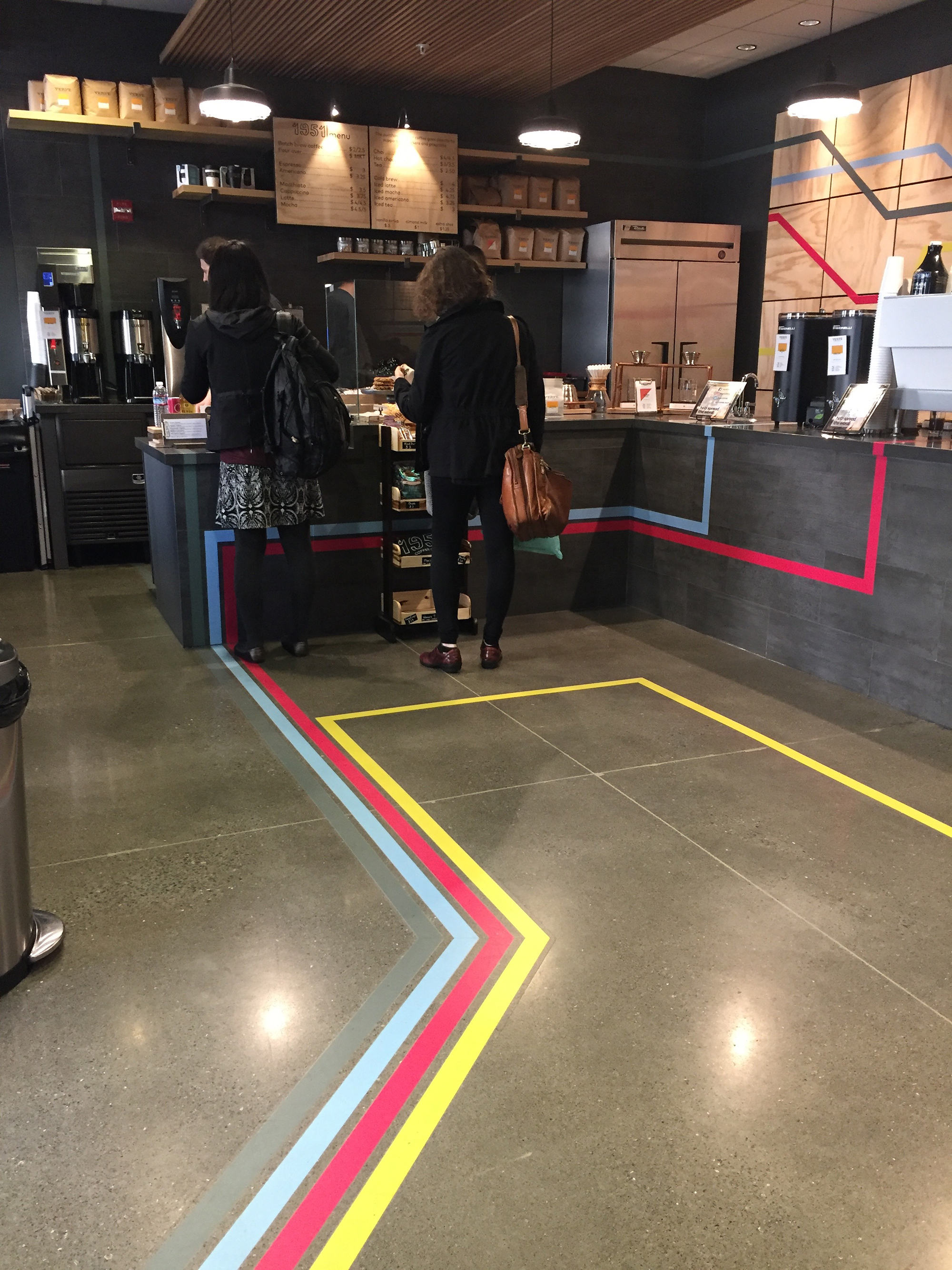 The colorful stripes on the cafe's floor suggest the long journey to resettlement.