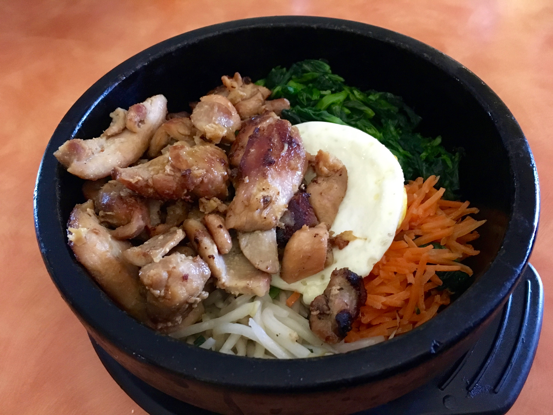 A hot stone pot with chicken and vegetables at Sunny Bowl.