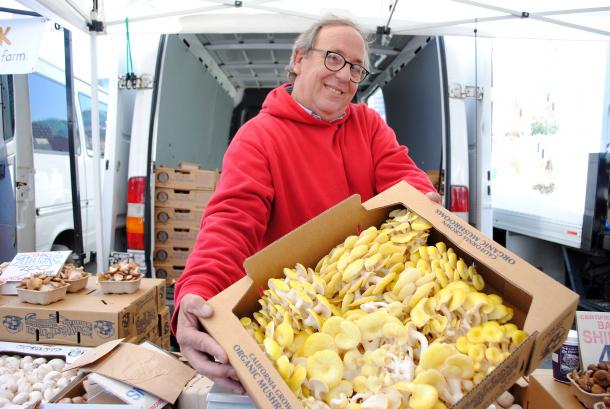 John Garrone (shown with yellow oyster mushrooms) can be found at the Ferry Plaza Farmers Market on Saturdays.