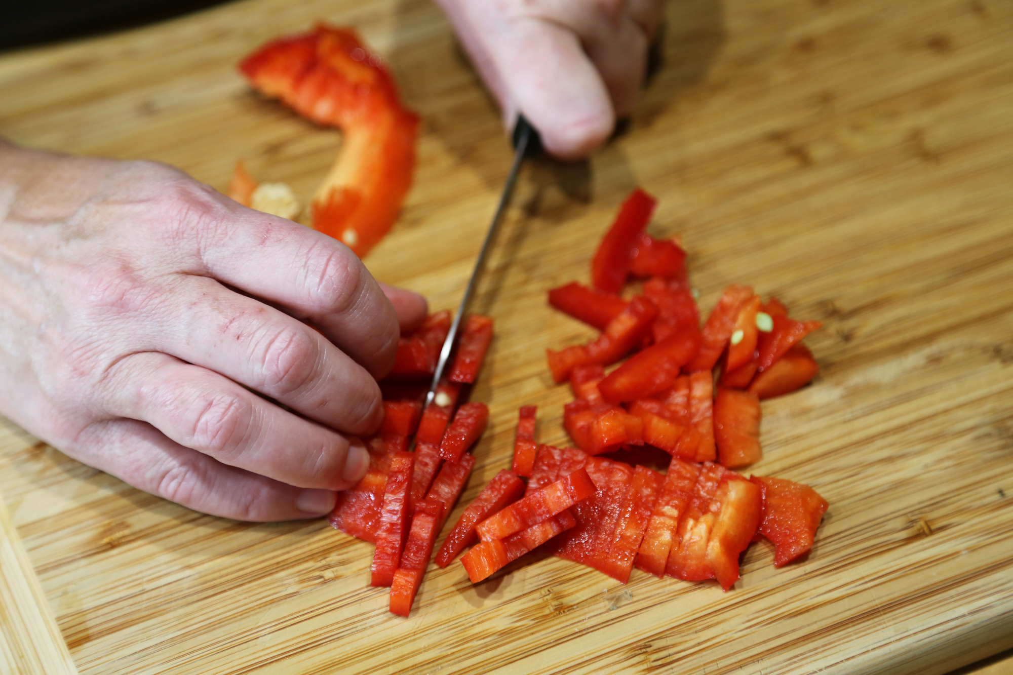 Seed and cut red bell pepper into thin 1-inch strips.