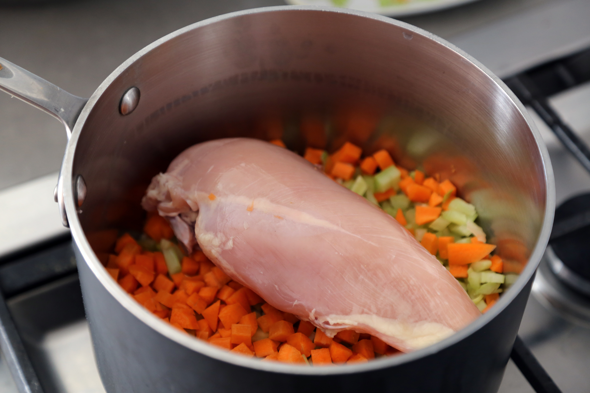 Add the prepped vegetables and chicken to the pot.
