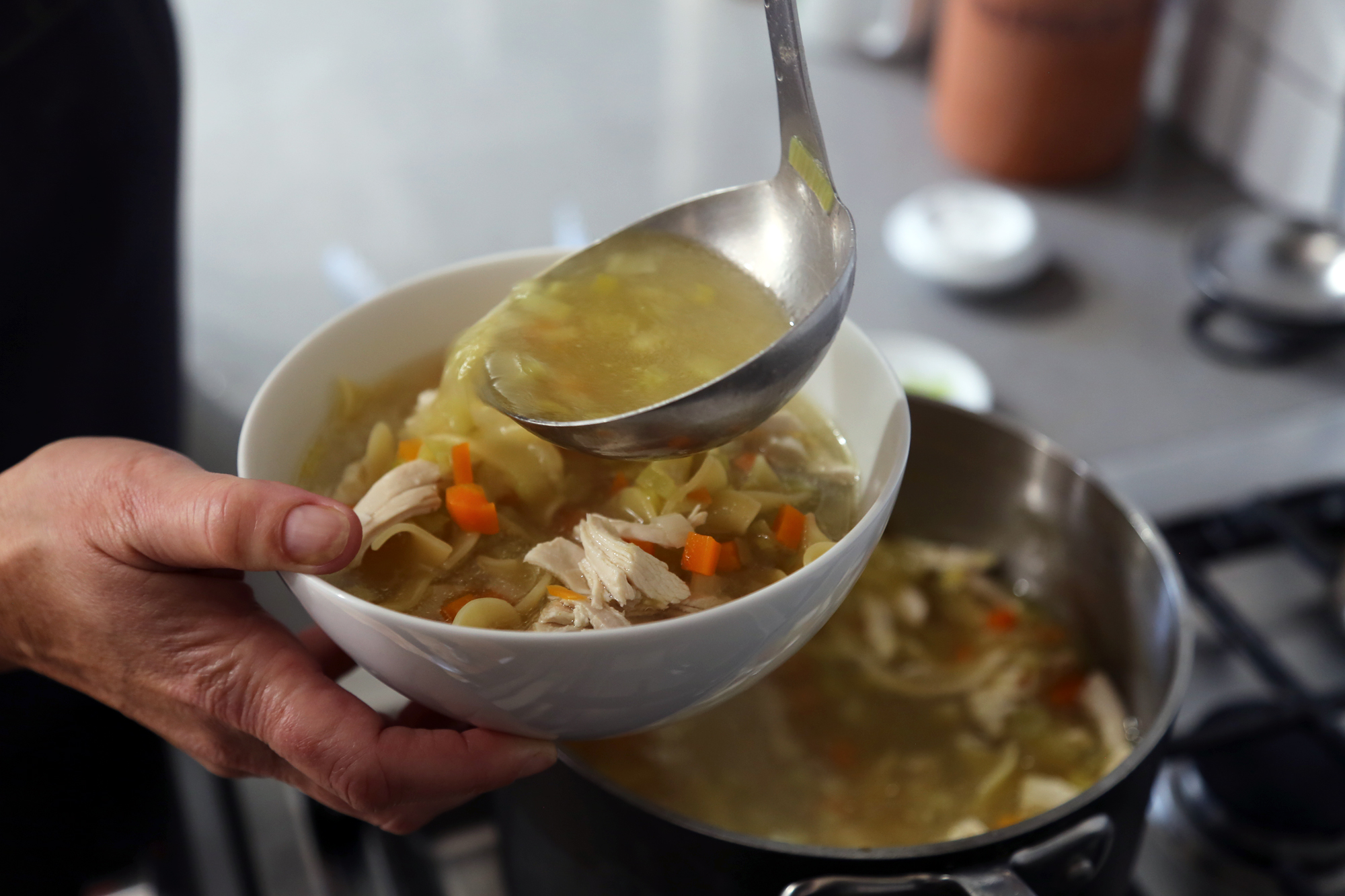 Ladle the hot soup into bowls.