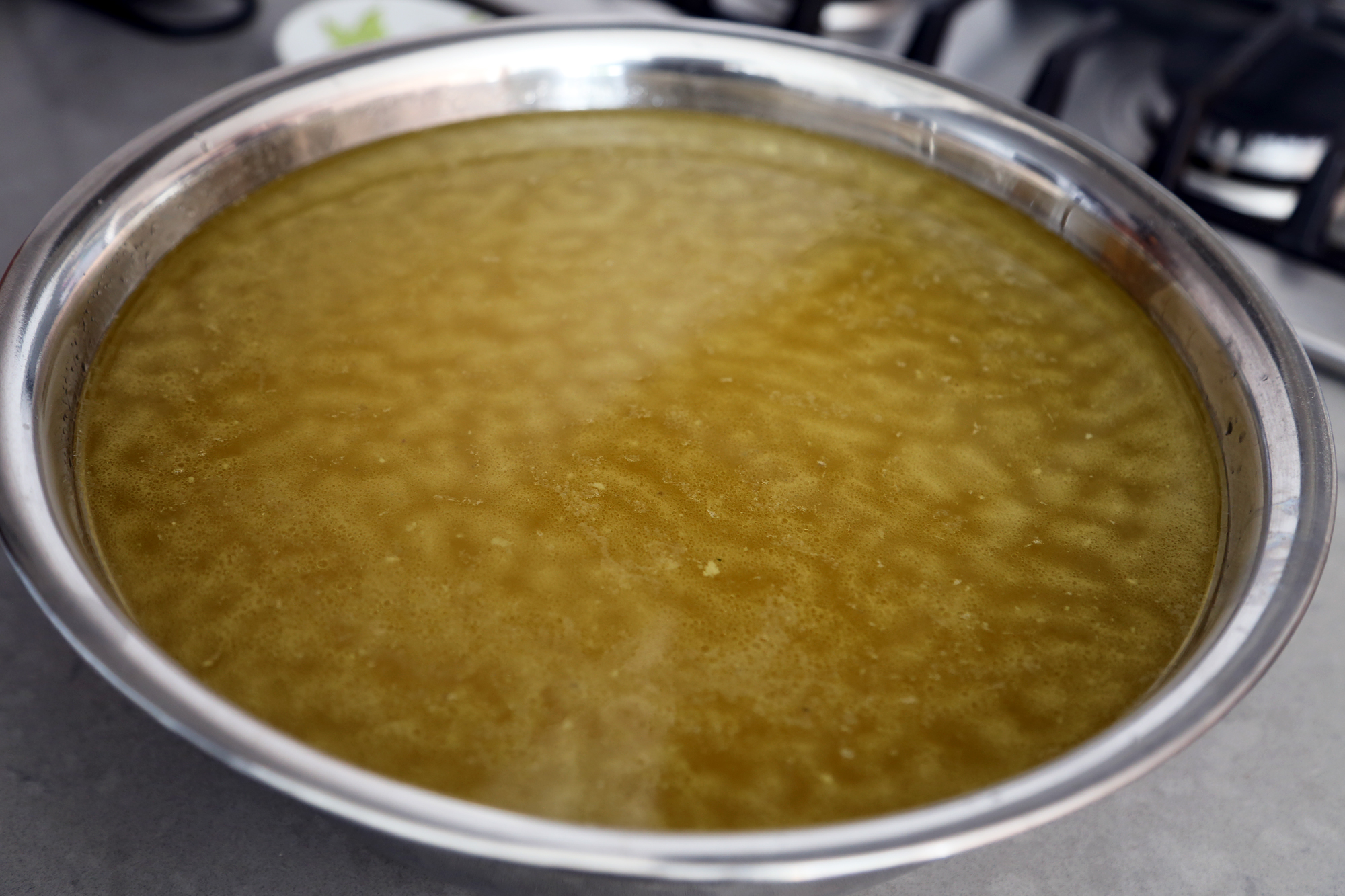 Let the stock cool to room temperature. Refrigerate in the bowl until chilled; remove the layer of fat on top of the stock.