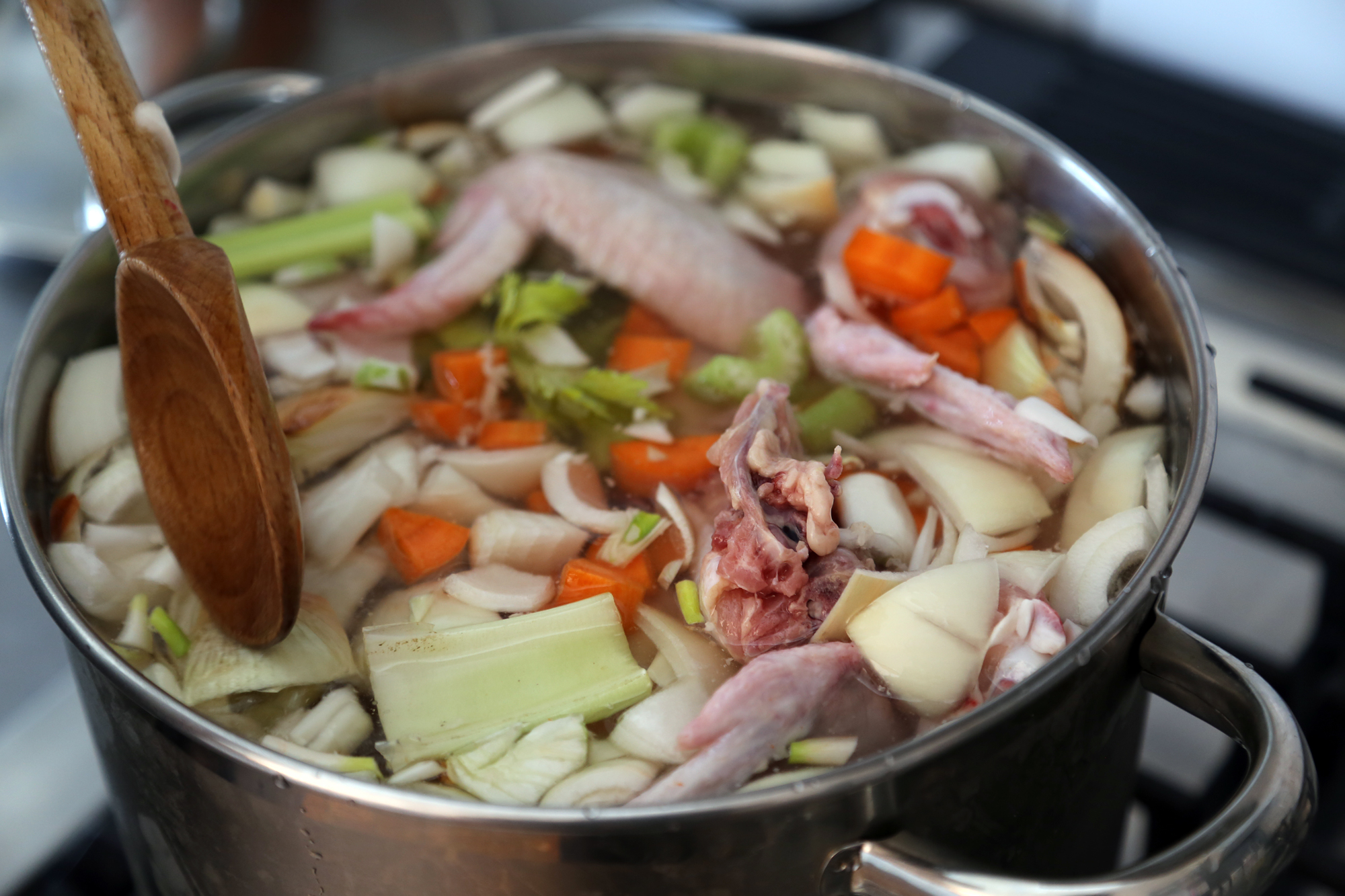 Combine the chicken parts, water, onion, carrots, celery, and parsley. Bring to a simmer over medium heat.