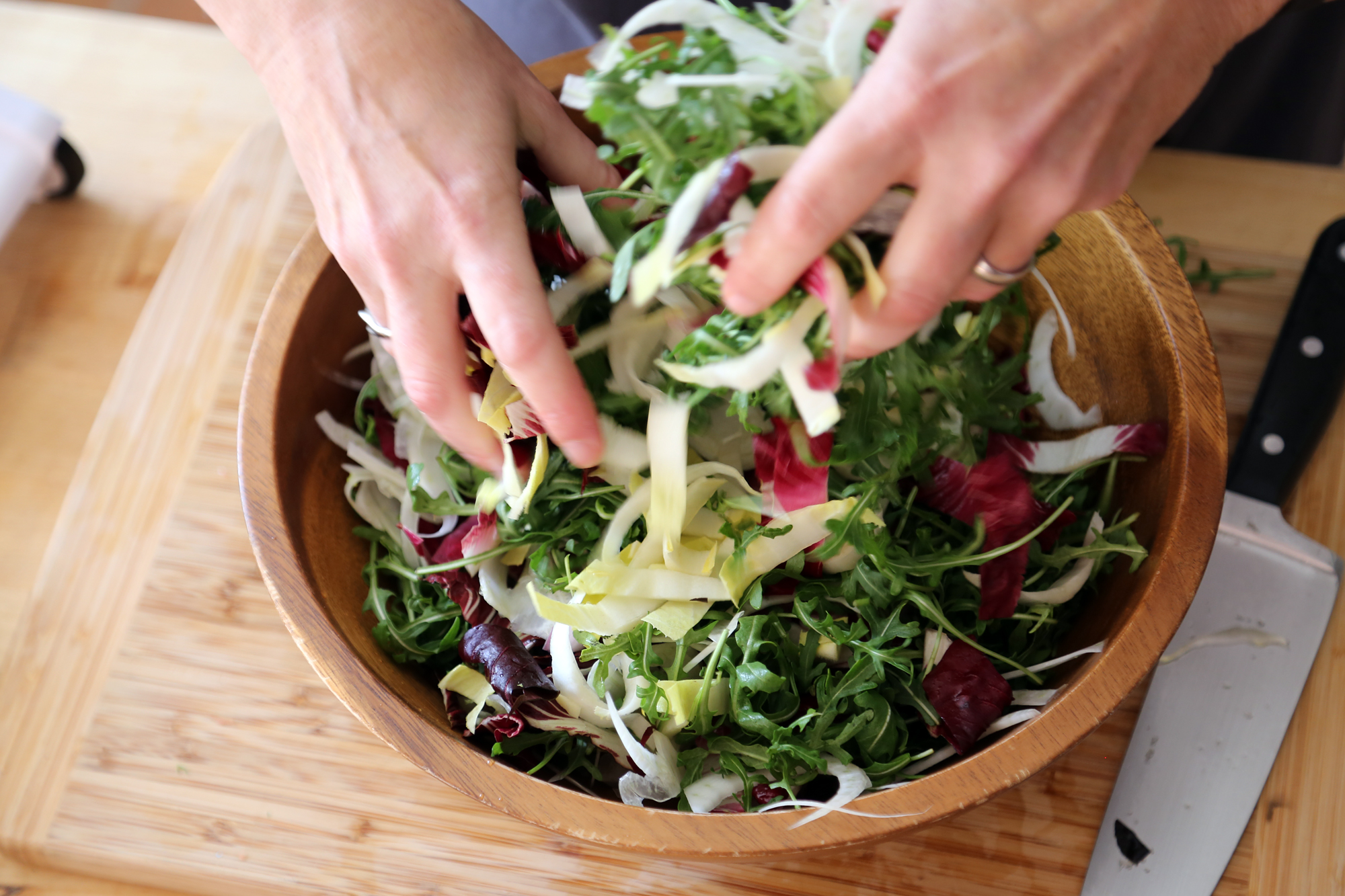 In a large salad bowl, toss together the arugula, radicchio, endive, fennel, and cilantro with a few tablespoons of the vinaigrette, enough to coat the leaves lightly.