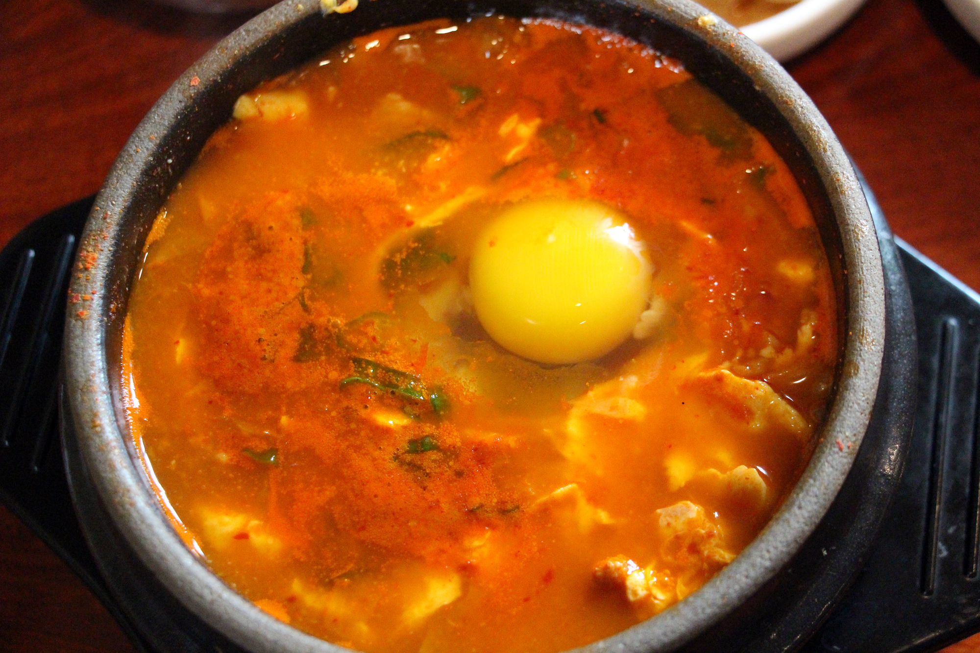 Soft tofu soup with pork, kimchi and a raw egg
