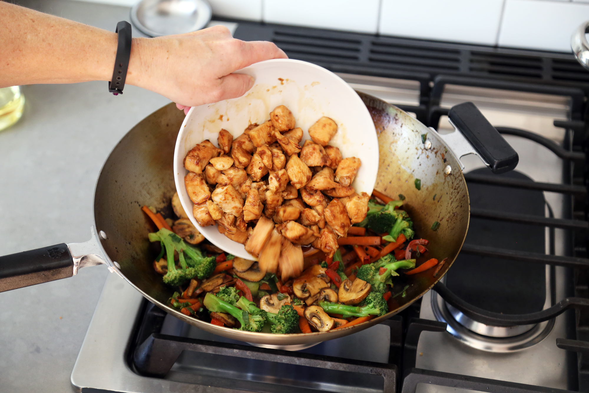 Add the chicken back to the wok along with the sauce.