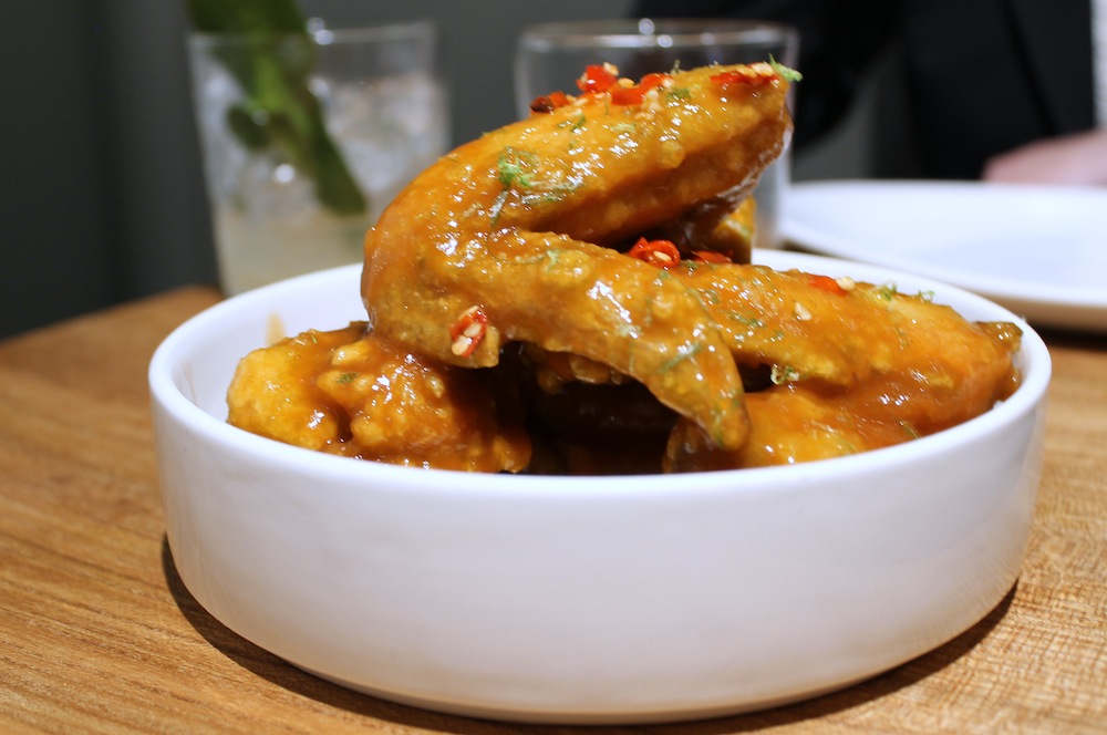 Kin Khao’s Pretty Hot Wings are glazed with a sriracha and tamarind sauce. 