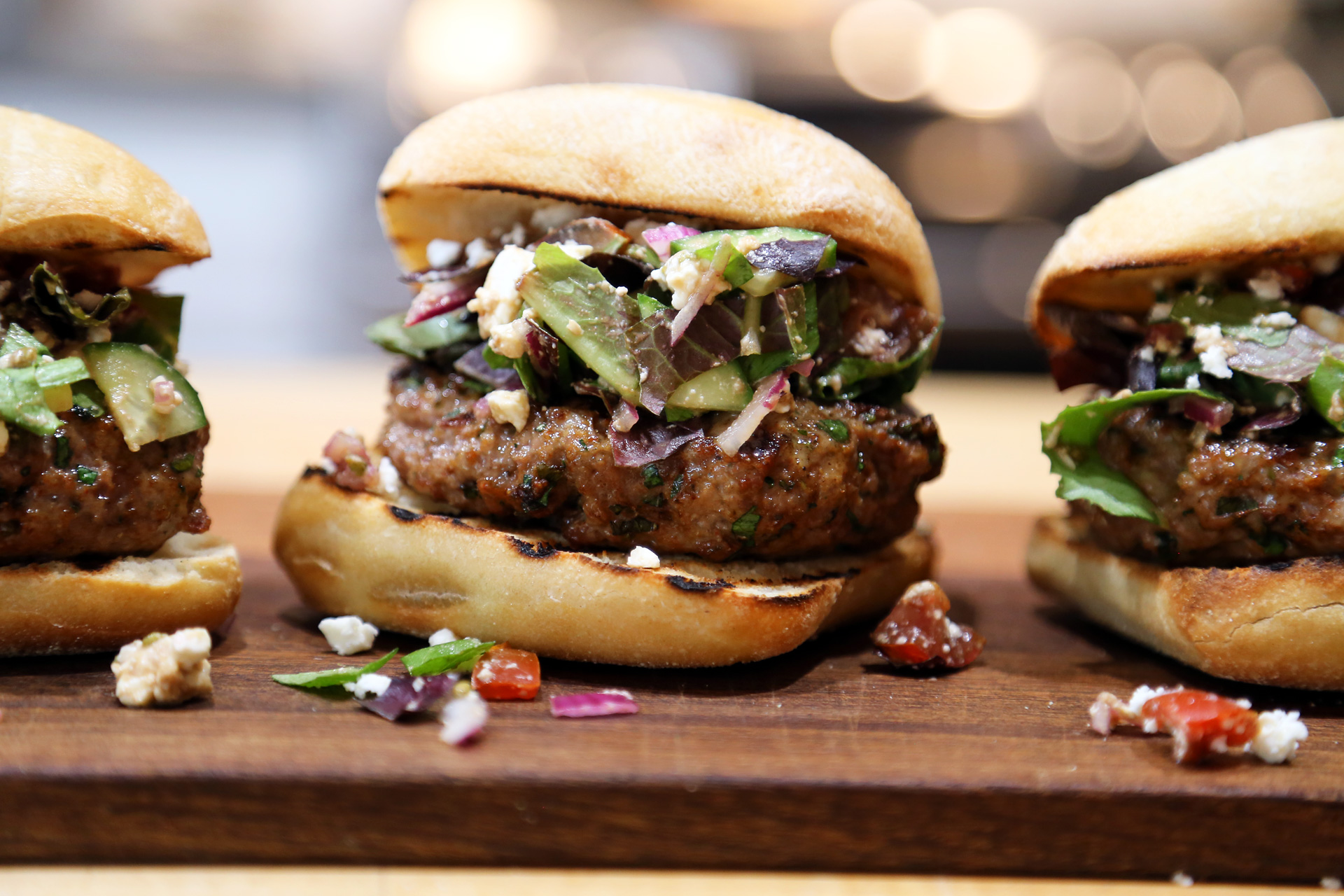 Herbed Lamb Burgers topped with Chopped Greek Salad