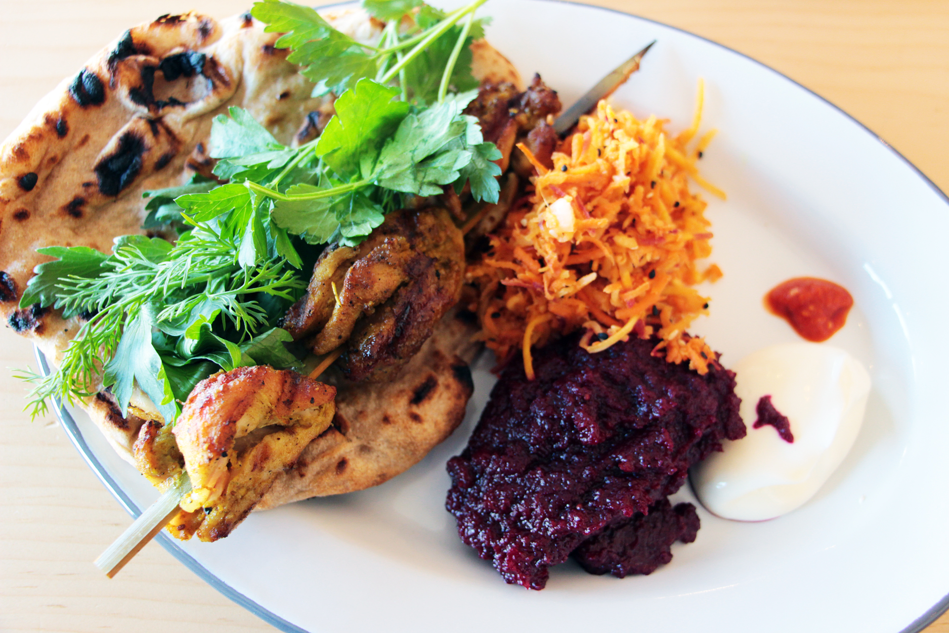 Chicken Kebab Plate, in a marinade of turmeric and other spices, grilled skin-on and served with flatbread, a raw carrot salad with caraway and mustard seeds and mashed beets.