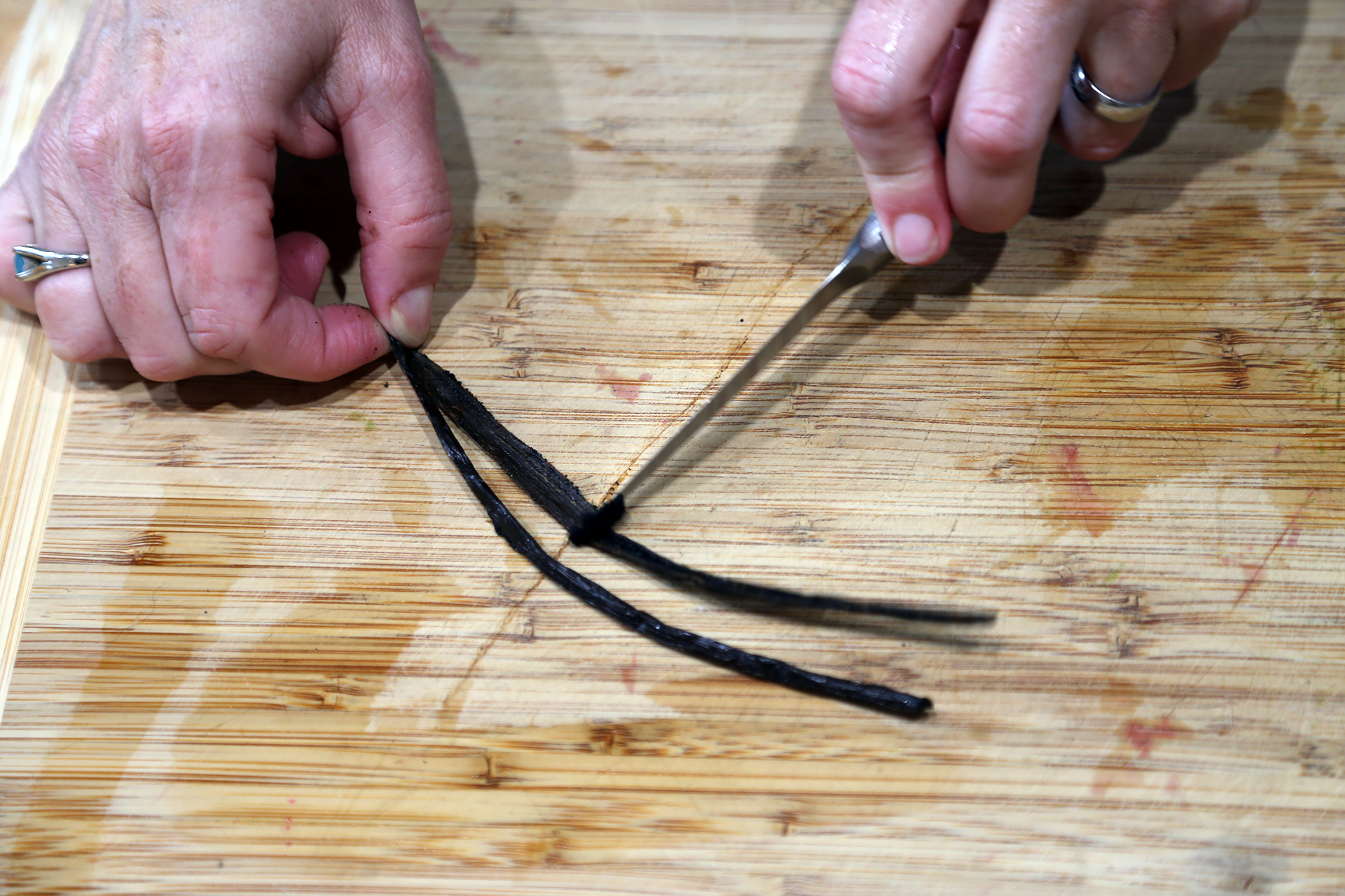 Using a paring knife, split the vanilla bean lengthwise, then, using the back of the knife, gently scrape the seeds from the pod.