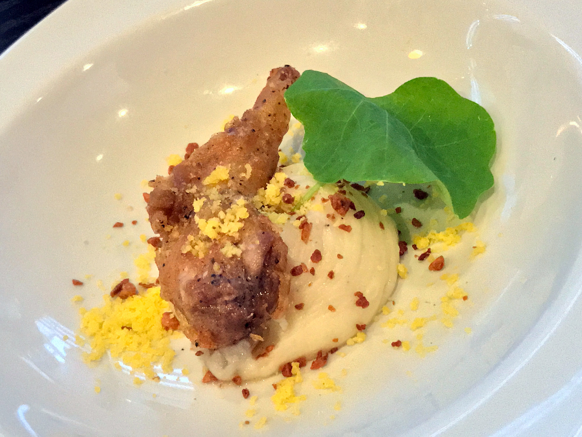 Crispy quail with roasted garlic, salted egg and mashed cassava.