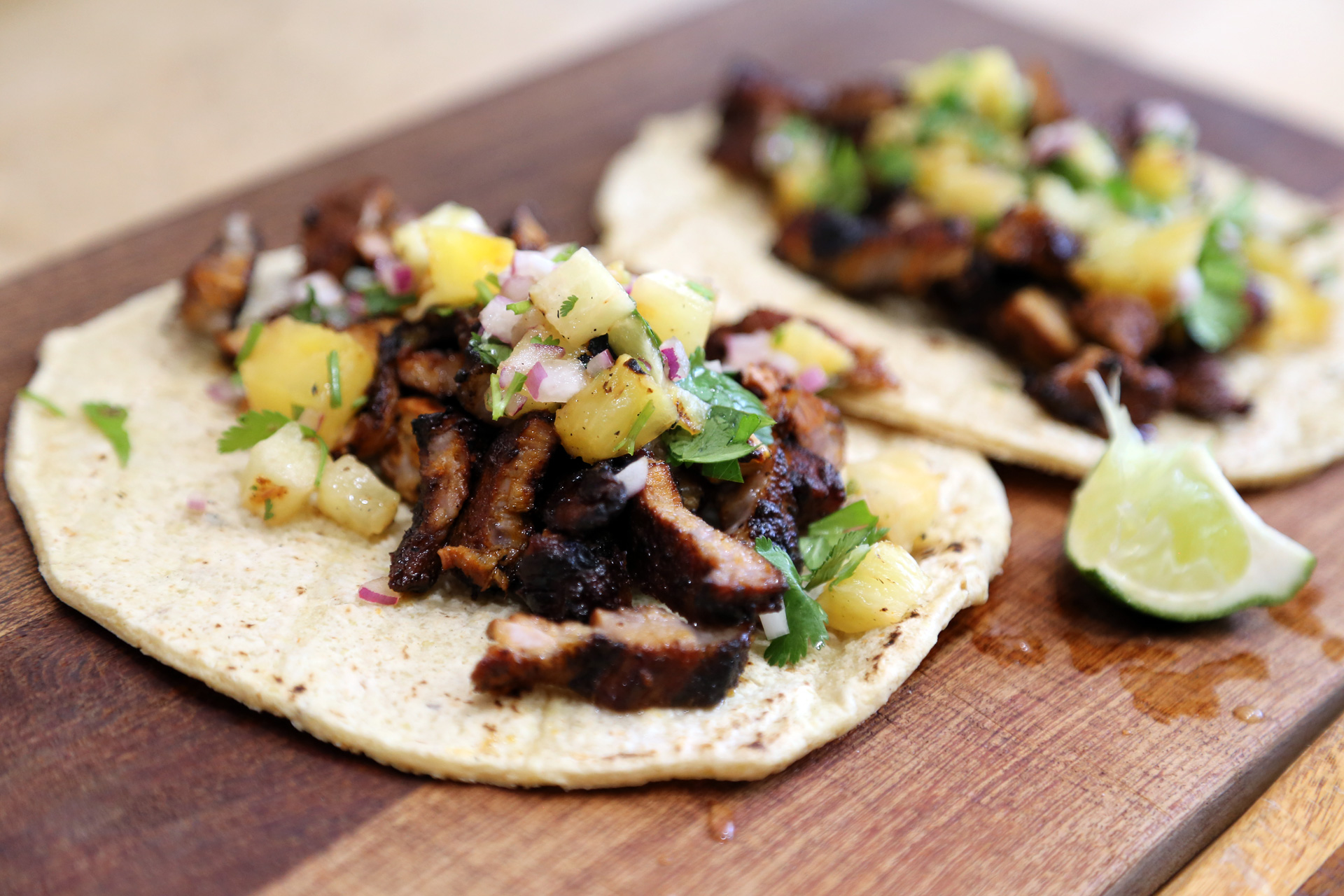 Serve Grilled Pork Tacos, Al Pastor Style with more lime on the side.