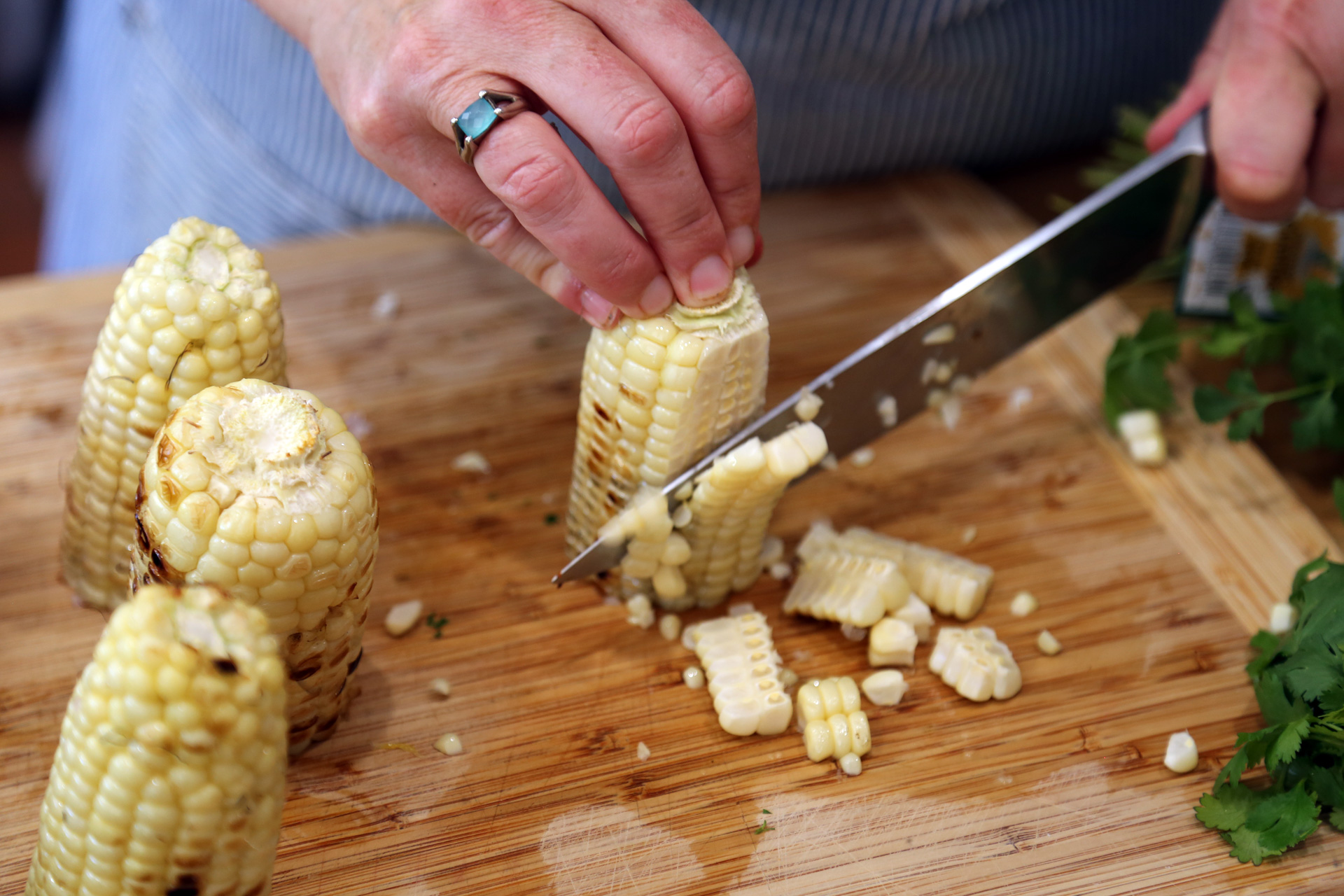 Transfer to a cutting board. Cut the kernels from the corn and place in a shallow serving bowl.