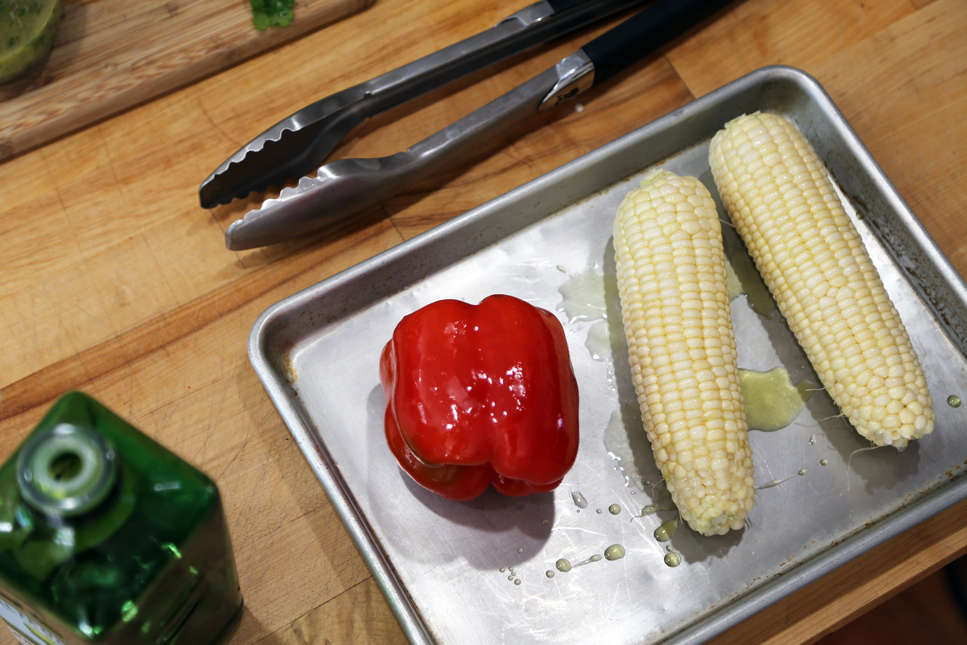 Coat the corn and pepper in olive oil.