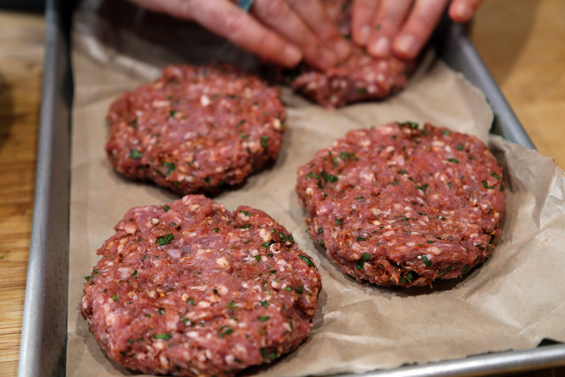 Form into 4 patties, each about 1/2 inch thick. Create a slight indentation in the center of the patty to keep it flat when it cooks.