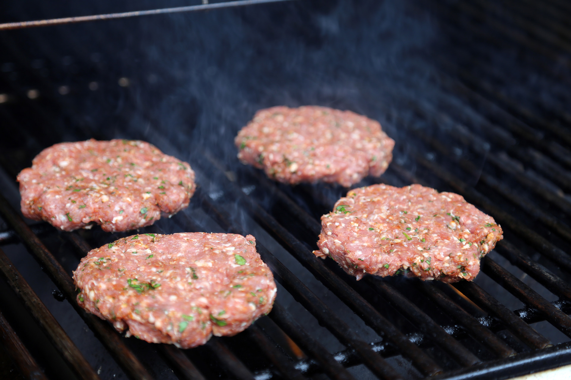 Grill the patties over the fire. 