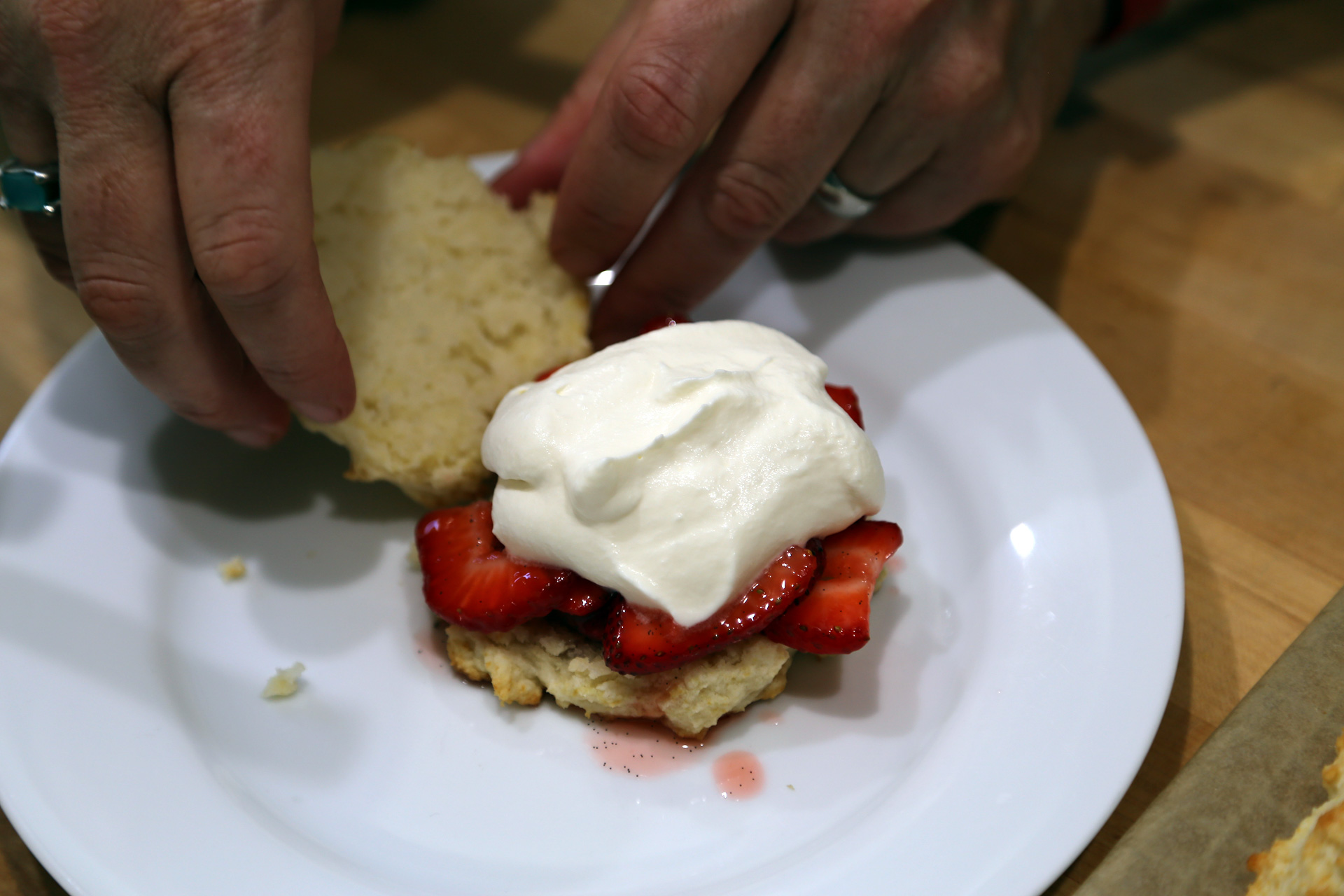 Top with a heaping spoonful of strawberries with the juices, some whipped cream.