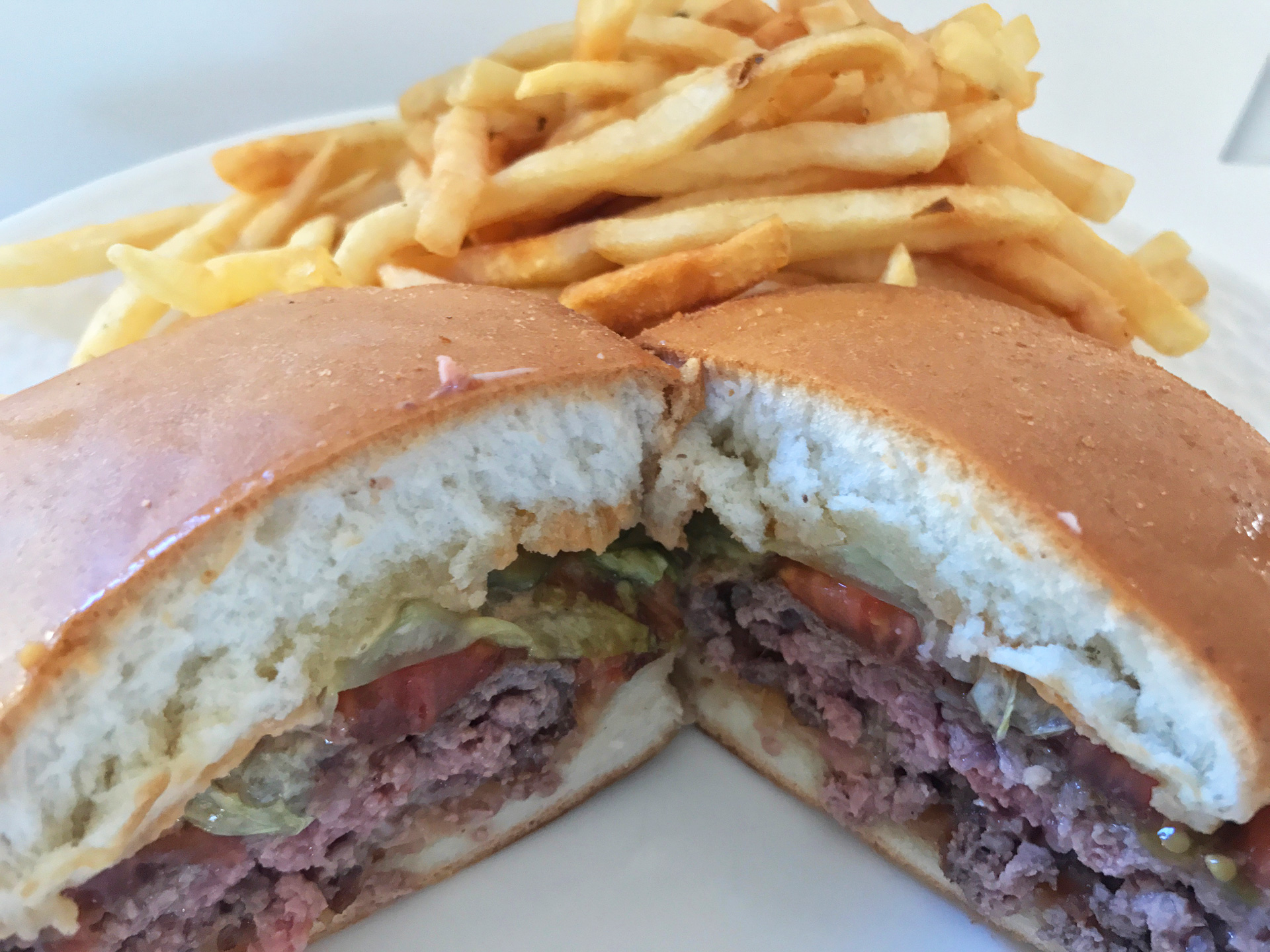 Bunaburger’s “Classic” Burger with red onions, lettuce, tomato, bread and butter pickles, and special sauce.