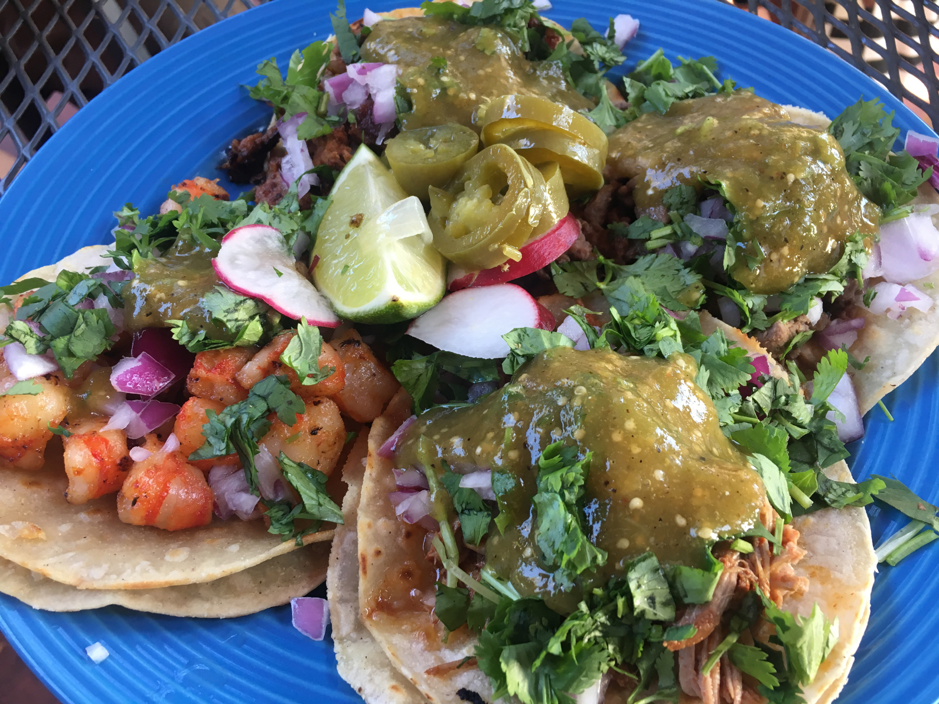A plate of shrimp, al pastor, carne asada and carnitas tacos at Speedy’s Tacos.