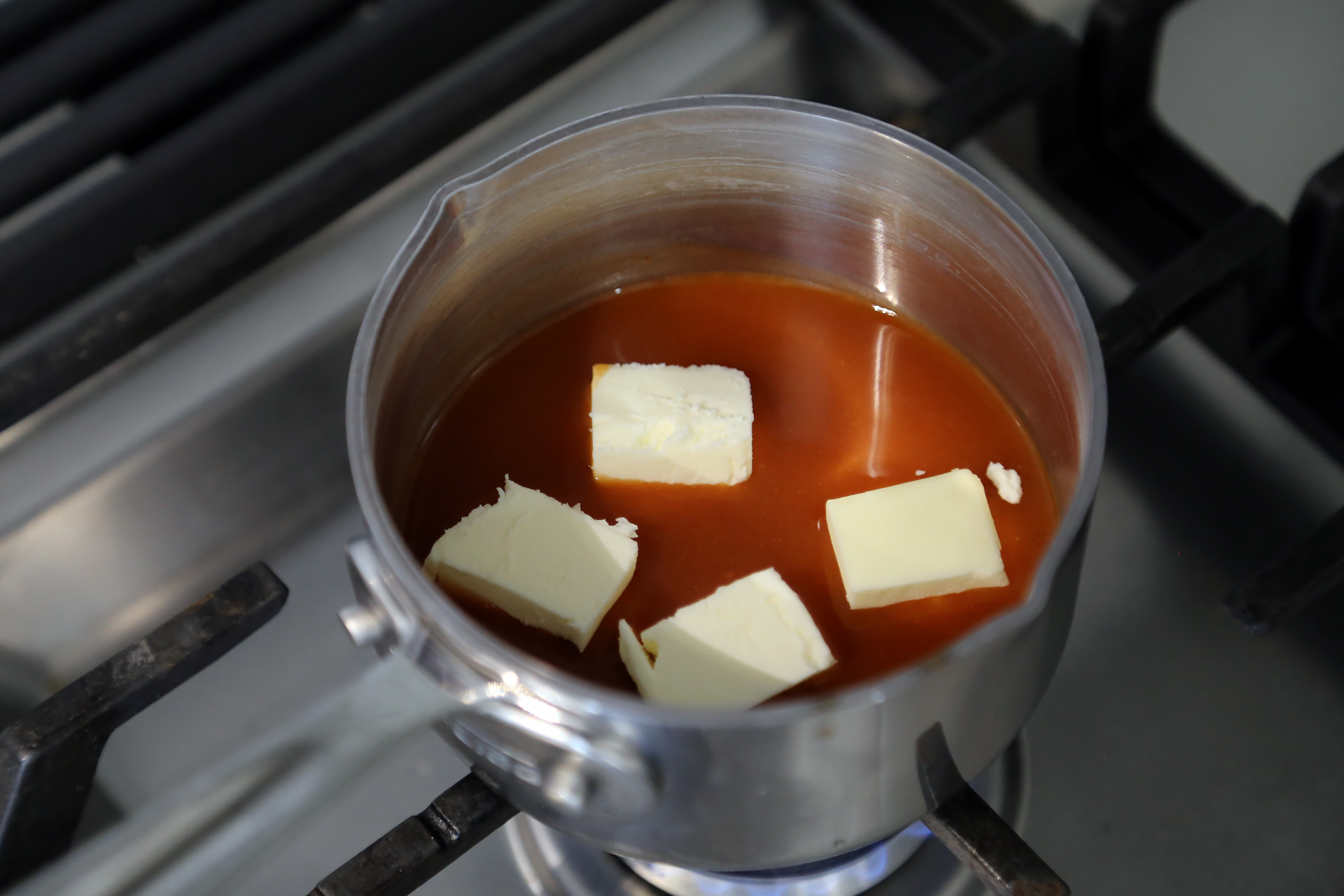 To make the sauce, in a small saucepan over medium heat, add the butter to the hot sauce and whisk to combine.