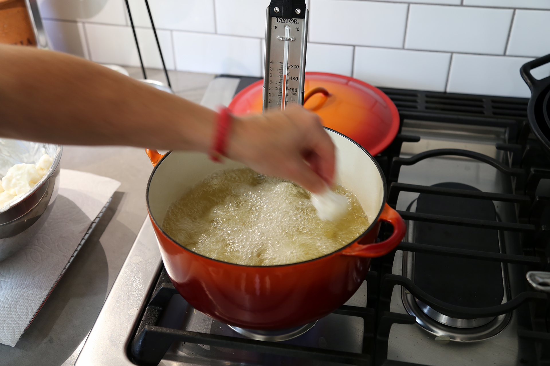 When the oil reaches 330F, pick up a floret, allowing any excess batter to drip off, and very carefully add it to the hot oil.