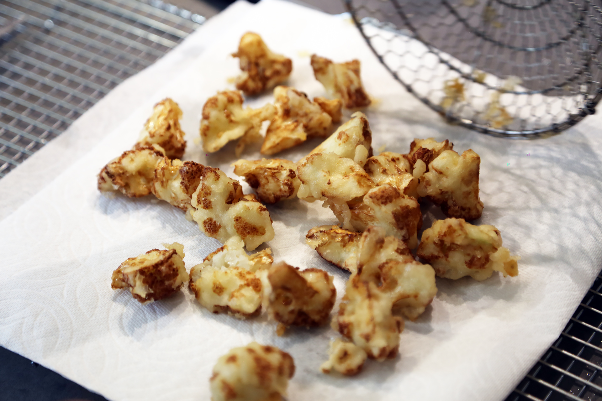 Using the spider or slotted spoon, transfer the fried cauliflower to the paper towels to drain, and season with salt.