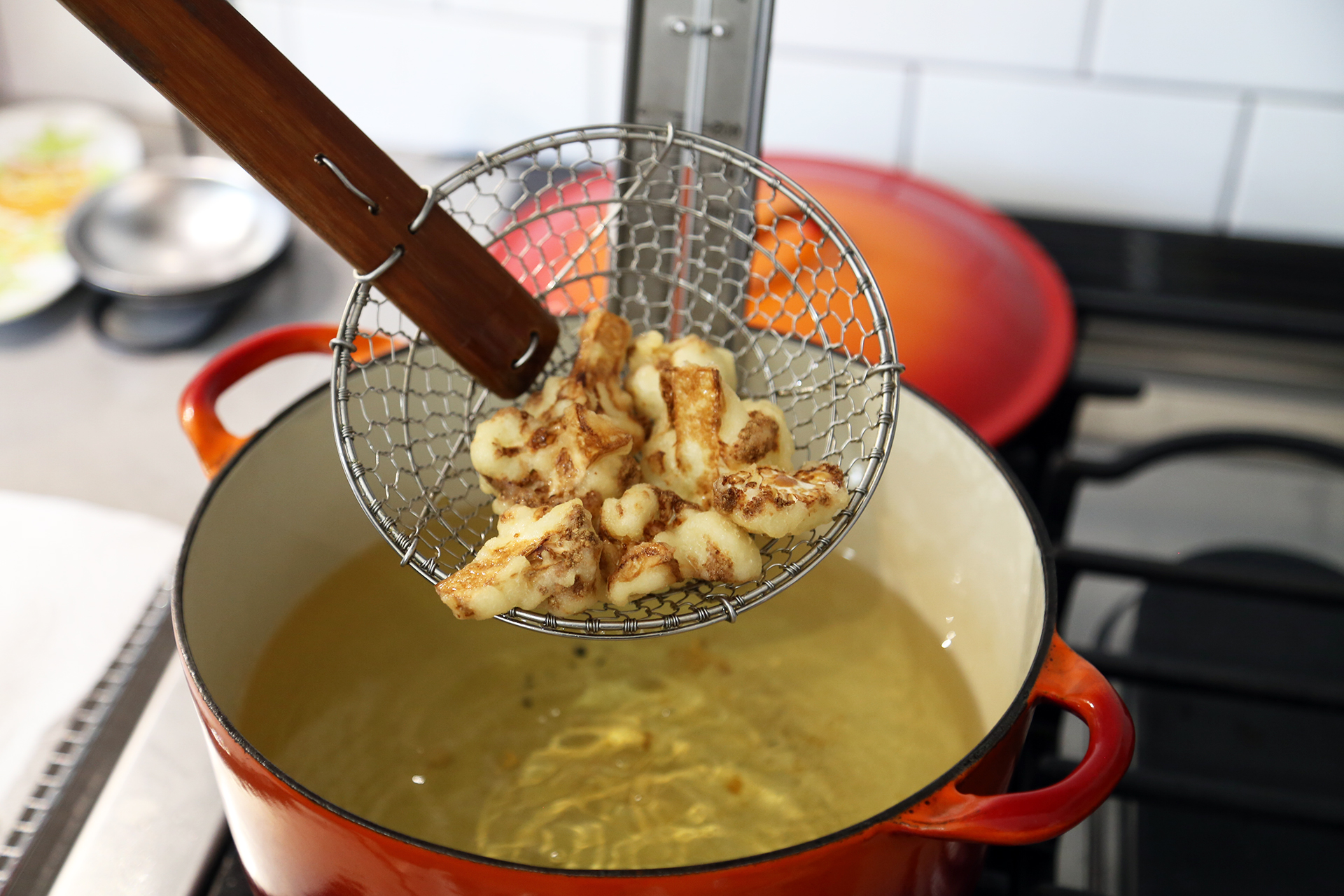 Fry the cauliflower, turning gently and occasionally with the spider, slotted spoon or tongs, until golden brown and crispy and the cauliflower is tender, about 6 minutes.
